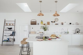 Escape For a Weekend Away at One of These Cornish Retreats That Fuse Old and New - Photo 2 of 14 - This modern beach house, just a mile from the harbor town of Porthleven, has an open kitchen, a double-side fireplace, and sweeping ocean views.