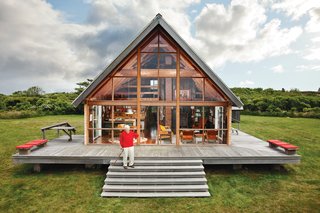 Midcentury designer Jens Risom's A-framed prefab family retreat, located on the northern portion of Block island, is bordered by a low stone wall, an aesthetic element that appears throughout the land.