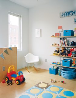 Philadelphia’s Postgreen Homes filled Chad and Courtney’s son’s room with an Eames rocker and a Hiya crib from Spot on Square. 