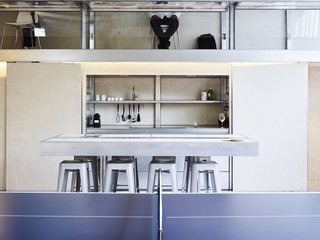 Across the Ocean - Photo 4 of 10 - Featuring double-height ceilings, the prefab addition includes a mezzanine level; Anton and Débora, who are codirectors of MIT’s POPLab (Prototypes of Prefabrication Laboratory), use the space as their home office. 