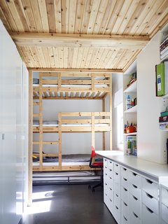 Across the Ocean - Photo 5 of 10 - A three-level bunk bed with an additional trundle furnishes the children’s room on the first floor; the cabinetry and drawers are from IKEA.