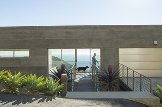 "Simple rectangular volumes with simple details" is how designer Thomas Egidi describes the house he created for architect Carlos Dell’Acqua in Malibu. "I wanted to stress its horizontality," Dell’Acqua notes. Inside the dwelling, which is entered via a bridge that pierces the 25-foot-high main facade, the view opens up to a panorama of mountains and sea. Ipe flooring is used for the walkway and throughout the interior. 