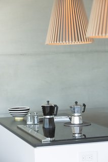 The kitchen features PaperStone counters, IKEA cabinets, and a Whirlpool induction range with a Jenn-Air downdraft vent.