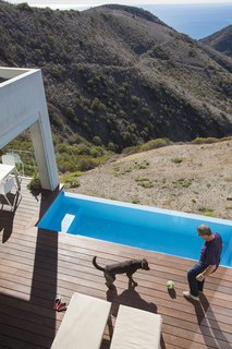 Cantilevered over the hillside is a stainless steel pool by Bradford Products. 