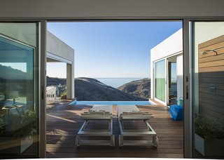 Lounge chairs by B&B Italia on the lower-level terrace offer a spot from which to take in the ocean views. Of the outdoor shower, Dell’Acqua says, "It’s the most used thing in the house—even in the middle of winter."