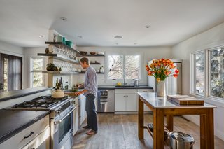 Juilland reused the existing cabinets but added custom fronts. The countertops are concrete and the fixtures are from California Faucets. 