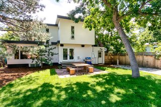 "We knew we had to connect the exterior to the interior," says Juilland, who added the large window to the living room and French doors to make it easy to get in and out from the kitchen. The custom picnic table is custom-made from Ben Dagitz.
