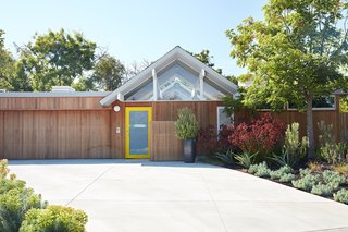 7 Modern Eichler Renovations in California - Photo 8 of 8 - Since the original siding was in bad condition, Klopf Architecture installed new vertical Western red cedar siding throughout the house, which is reflected on both the interior and exterior. They explained that one of the challenges of the project was finding a low-VOC stain that would match the color of the original siding. 