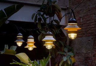 Extend Your Time Outside With These 6 Innovative Lighting Designs For Your Outdoor Space - Photo 5 of 5 - Marset’s Santorini lights were designed by Sputnik Estudio. Available in white, gray, or mustard, the outdoor lamps are inspired by fishing boat lanterns and can be customized for your space—including how many shades to place on the diffuser, the order, position, and direction.