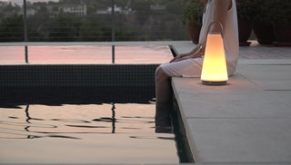 Extend Your Time Outside With These 6 Innovative Lighting Designs For Your Outdoor Space - Photo 4 of 5 - Designed for both indoors and outdoors, this portable lamp by Pablo Studio works as both a speaker and a light that features bluetooth connectivity, full-range dimming control, and a touch-sensitive volume control.