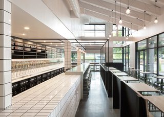 10 Brewpubs That Have Tapped the Art of Modern Design - Photo 5 of 12 - The wall behind the long and narrow bar offers 48 taps of different craft beers.