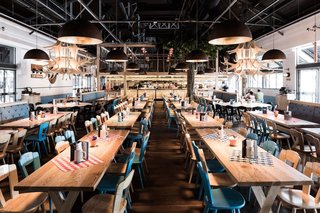 10 Brewpubs That Have Tapped the Art of Modern Design - Photo 6 of 12 - Located in a former goods shed, Munich Brauhaus can hold 900 guests, many of which can gather in the main dining space that’s filled with long communal tables—a brauhaus necessity.