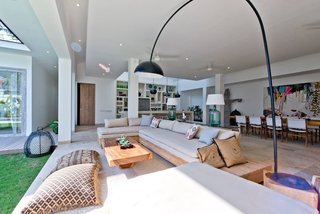 Connect With Bali's Tropical Landscape at One of these Modern Villas - Photo 1 of 10 - The four-bedroom Villa Momentai in Canggu (also shown in the cover photo above), can comfortably accommodate eight guests. Large sliding glass doors connect the modern interiors with a pool and lush, breezy yard. 