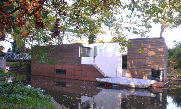10 Modern Floating Homes That Offer an Aquatic Lifestyle - Photo 3 of 10 - Anchored beside a wooded parkland, this houseboat in the Netherlands was designed by BYTR Architects.