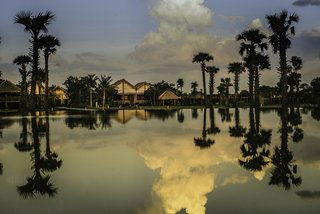 Hide Out in One of These Asian Retreats That Are Immersed in Nature - Photo 4 of 12 - Located between Tonlé Sap lake and the Kulen mountains in Cambodia, Phum Baitang is set within eight acres of lush tropical gardens and paddy fields in Siem Reap. The exterior of their 45 stilted villas follow the traditional Khmer style, while the interiors are contemporary and warm. This is a great place to stay if you’re planning on exploring the ruins of Angkor.