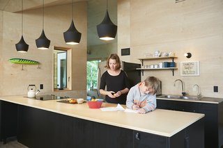 Hot to Trot - Photo 3 of 11 - In the kitchen both the walls and the countertop are made of birch plywood. A quartet of black Tom Dixon Beat lights hangs overhead. 