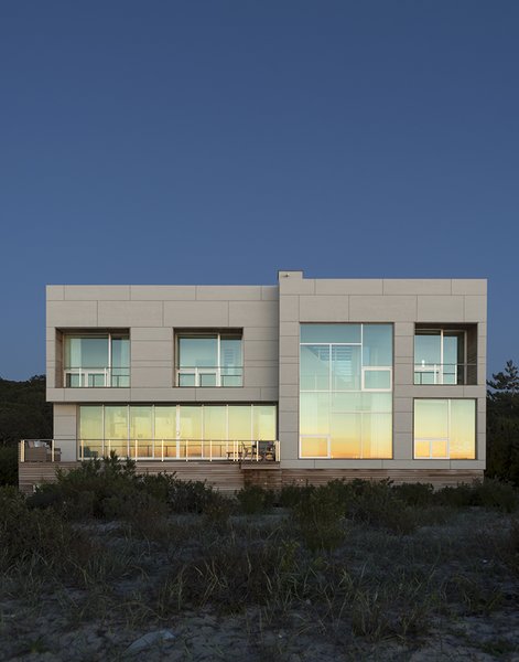 When Superstorm Sandy struck the East Coast in fall 2012, Margaret and Bob Bombara were in the middle of planning their long-awaited beach house on Long Island’s North Fork. The disaster, which flooded their main home in Queens, gave them pause. For architect John Berg, it underscored a vital fact—the Bombaras’ vacation house would need to be able to stand up to high wind, heavy rain, and intense storm surges. Photo 2 of North Sea House modern home