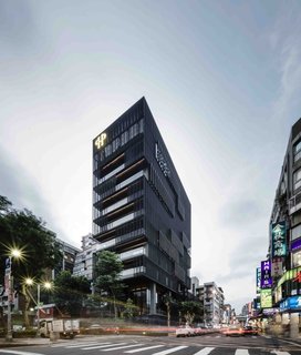 Visit 12 Design-Centric Stops in the Asian Metropolis of Taipei - Photo 2 of 13 - Newly opened in 2016, the postmodern Hotel Proverbs stands tall behind a minimalist dark patchwork mesh facade. Designed by noted Taiwanese architect Ray Chen, the eye-catching hotel has an equally stunning bakery and restaurant—both in stark contrast to the bustling night market that takes place in the neighborhood below. 