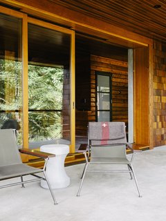Sling chairs by Garza Marfa flank <br>a Made Goods concrete table.