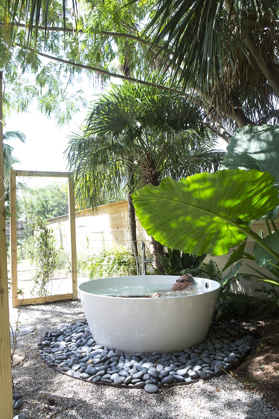 40 Modern Bathtubs That Soak In the View Outdoor Tub: A tucked-away bathtub provides a private backyard oasis. “We kind of got carried away,” resident Maury Strong recalls of the decision to place the 59-inch freestanding Keren basin outdoors. “My view was, ‘Let’s just do it all.”’ The extra effort paid off—the outdoor bath is among her grandchildren’s favorite parts of the house. Her husband, Ron Caron, also enjoys relaxing there.