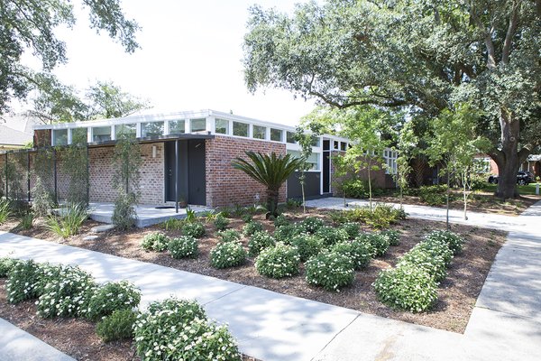 Plantings: Evans + Lighter Landscape Architecture, contractor Sandra Tomasetti, and architecture firm studioWTA collaborated to develop a roofline without gutters above the walkway and carport. Instead, water is channeled to feed the garden. The result is a California-inspired yard with geometrically laid-out plantings rather than grass. “It’s rows of green with mulch permeating,” Maury says. Photo 10 of Emerald Street Residence modern home