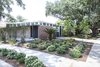Plantings: Evans + Lighter Landscape Architecture, contractor Sandra Tomasetti, and architecture firm studioWTA collaborated to develop a roofline without gutters above the walkway and carport. Instead, water is channeled to feed the garden. The result is a California-inspired yard with geometrically laid-out plantings rather than grass. “It’s rows of green with mulch permeating,” Maury says. Photo 10 of Emerald Street Residence modern home