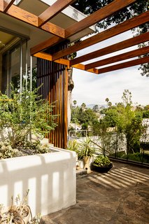 Andrew worked with contractor Miguel Perez to rebuild the home's redwood trellis, matching the stain to the adjoining slat screen, which is original. 
