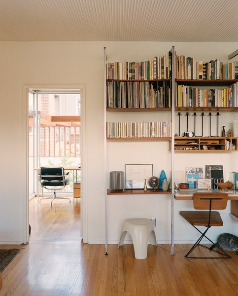 Eric Lamers of Hammerhead, a craft-based contractor specializing in midcentury renovation projects, worked on the house before Andrew and his wife, Dustin Ferrer, acquired it in 2013, but it still needed a good deal of restoration. The home features an impressive collection of vintage furnishings, including an Elephant Stool by Sori Yanagi and a Luther Conover chair. The CSS shelving unit is by George Nelson. Photo 4 of The Romano-Ferrer Residence modern home