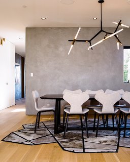 Domino Effect: How a Bedroom Refresh Jump-Started a Whole-House Remodel For a Tech Exec - Photo 10 of 14 - Fritz Hansen Grand Prix chairs, a Lindsey Adelman Agnes Chandelier, and a Kyle Bunting Runway rug furnish the dining room. 