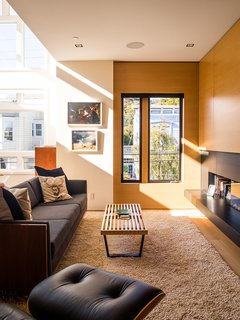 Domino Effect: How a Bedroom Refresh Jump-Started a Whole-House Remodel For a Tech Exec - Photo 8 of 14 - In the living area, a restored Milo Baughman sofa and a Nelson Platform bench join an Ortal fireplace. 