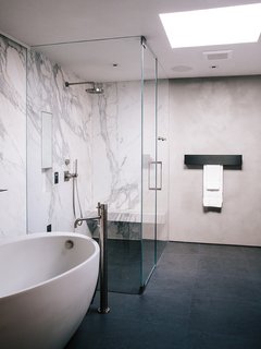 Domino Effect: How a Bedroom Refresh Jump-Started a Whole-House Remodel For a Tech Exec - Photo 6 of 14 - In the master bathroom, a freestanding Waterworks tub is paired with a Fantini fixture. Calacatta marble surrounds the shower; the flooring is Evolution ceramic tile from Apavisa. 