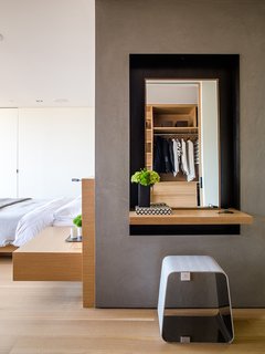 Domino Effect: How a Bedroom Refresh Jump-Started a Whole-House Remodel For a Tech Exec - Photo 5 of 14 - Like the bed and built-in nightstand, the door is by Lloyd’s Custom Woodwork. The WGS stool near the vanity is by Gallotti&Radice. 