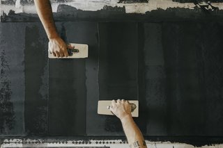 Paper Trail - Photo 6 of 16 - Coat: Using traditional Italian plaster trowels, the team applies a base coat of plaster that has been mixed with marble dust. 