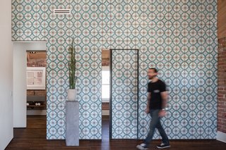 11 Examples of How to Incorporate Traditional Building Materials Into Your Modern Home - Photo 4 of 12 - Off the living room, two small bedrooms and a bathroom can be reached through sliding doors that, when closed, continue the cheerful pattern of the Moroccan cement tiles covering the wall.