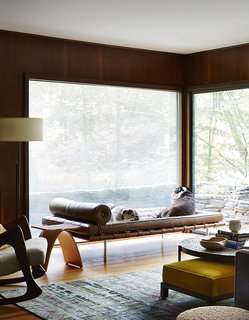 How to Update a Midcentury Modern Gem - Photo 9 of 12 - Bulldogs Sasha and Sophie rest on a Mies van der Rohe daybed in the lower den. The Capelli stool by Carol Catalano and the rocker by Adrian Pearsall are reserved for their owners. 