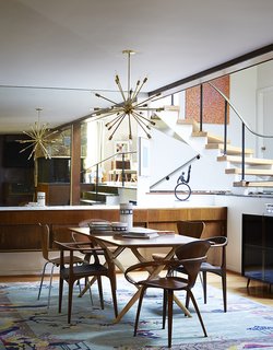 How to Update a Midcentury Modern Gem - Photo 3 of 12 - Mostly they restored original elements, like the buffet and the staircase. Cherner chairs sit at the head of a Design Within Reach table. The armless Series 7 chairs are by Arne Jacobsen; the third pair are Juliana chairs by Aristeu Pires.