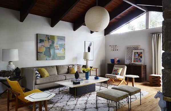 Modern home with living room. The house is like an anthology of modern design, spread out across 4,300 square feet. In the formal living room alone, there’s a Japan chair by Finn Juhl, a Hang-It-All rack by Charles and Ray Eames, a Scissor chair by Pierre Jeanneret, a Wiggle stool by Frank Gehry, and an Akari lamp by Isamu Noguchi. George began his collection in the 1990s with a pair of Paul McCobb stools, which sit near the fireplace. Photo 6 of The Marrone/Nocera Residence