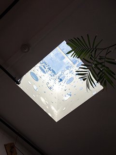 Devising Clever Solutions For a Small San Francisco Loft - Photo 3 of 10 - Circular mirrors adhere to the inner walls of a skylight above the dining area, bouncing light and bringing the room yet more illumination. 
