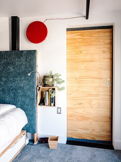 Devising Clever Solutions For a Small San Francisco Loft - Photo 4 of 10 - For his bedroom, Max designed a custom headboard insulated with several layers of cotton and upholstery fabric to reduce sound.