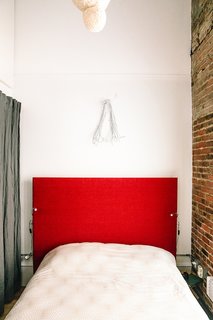 Devising Clever Solutions For a Small San Francisco Loft - Photo 9 of 10 - A bedroom next to the living area has an overhead lantern Max made by wrapping string soaked in glue, water, and corn starch around an inflated balloon, deflating it, and then lining it with rice paper-mache.