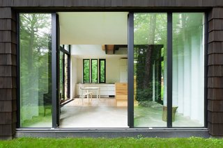 The interior is spare and modern. The cabinets and chairs are from IKEA. So is the table, which has a DIY laminated-ash top. Suzanne Rochon bought the cabin in 2002 and spent a decade fixing it up before calling on YH2 Architecture. In 2005, she added five acres, doubling the property. 