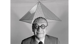 I.M. Pei with a model of Le Grand Louvre on his head.