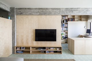 Lisbon Vision - Photo 3 of 5 - The living room is defined by a large birch plywood television console, designed by architect, Miguel Marcelino. 