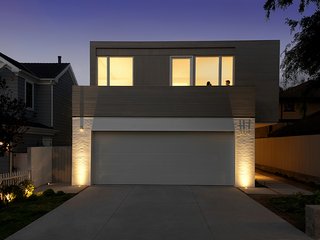 Two Grad-School Friends Apply Their Know-How to a Manhattan Beach Bungalow - Photo 1 of 9 - The facade of the home displays a combination of materials: painted brick on the ground floor and stained cedar above. 