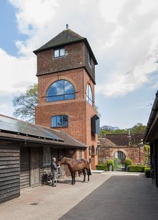 A Refurbished Victorian-Era Brick Tower in Hampshire - Photo 1 of 9 - In Fritham, England, Andrew Hollins and Sheryl Wilson repaired a water tower with the help of PAD Studio. An adjoining cottage containing bedrooms, a kitchen, and more is outfitted with LG solar panels. 