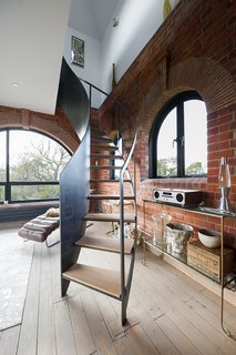 A Refurbished Victorian-Era Brick Tower in Hampshire - Photo 4 of 9 - Littlehampton Welding made the steel staircase on the third floor.