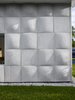 Modern home with Outdoor, Side Yard, and Grass. “For the majority of the day, when the sun is high, you almost don’t notice the texture on the exterior. It just fades into a flat wash,” says designer Nick Gelpi of the undulating wood-based concrete tiles that clad his home in Miami Beach. “But at moments, the sun hits at a certain angle and really activates the surface.” Photo 2 of Exotic Concrete House