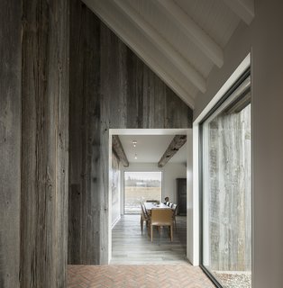 An Artist and Farmer Work With a Toronto-Based Studio to Build a Barn-Inspired Home - Photo 4 of 11 - Verona chairs from Structube surround a vintage dining table. 