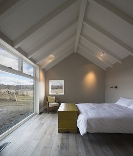 An Artist and Farmer Work With a Toronto-Based Studio to Build a Barn-Inspired Home - Photo 5 of 11 - The LAMAS team studied local and regional vernacular before beginning the design. "Many of the towns around here have a New England architecture. It's more Vermont-looking than the typical Quebec village," architect James Macgillivray notes. An antique blanket box is one of the few furnishings in the master bedroom. 