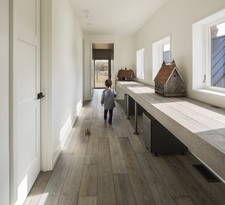 An Artist and Farmer Work With a Toronto-Based Studio to Build a Barn-Inspired Home - Photo 9 of 11 - Antique-looking birdhouses are displayed in a hallway office space upstairs. 
